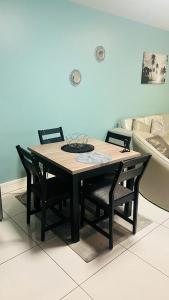 a dining room table with chairs and a boat at Windhoek City Center self catering appartment on independance 77 unit 95 in Windhoek