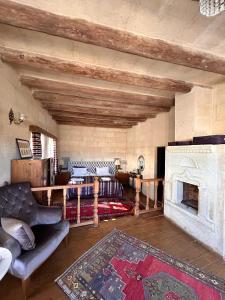 a living room with a couch and a fireplace at Hotel Temenni Evi in Urgup