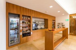a kitchen with a counter and a refrigerator at Hotel Simplicity by Bad Schönbrunn in Menzingen