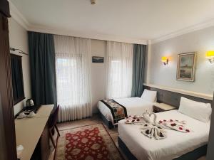 a hotel room with two beds and a window at Maritime Hotel Istanbul in Istanbul