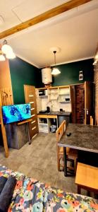 a kitchen with a table and a dining room at Studio Centrum Wejście na kod Code entry in Szczecin