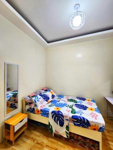 a bedroom with a bed and a mirror at Serene 2BR Escape: Poolside Bliss in Iloilo City in Iloilo City