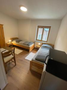 a room with two beds and a window at Paltenhof in Selzthal