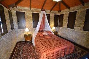 a bedroom with a bed with a mosquito net at Relais Villa Rossi in Silvi Marina