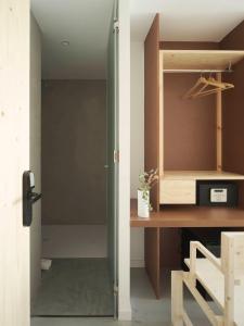 a door leading into a room with a wooden desk at Hotel Amiuka in O Pedrouzo