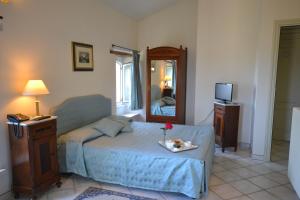 a bedroom with a bed and a mirror at Relais Villa Rossi in Silvi Marina