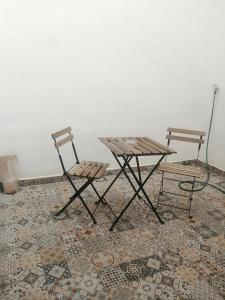 dos sillas y una mesa de picnic en una alfombra en Casa Rural con Estilo Valdepeñas, en Valdepeñas
