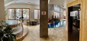 a hotel lobby with a swimming pool in the middle at Apartament Szafran ApartamentyZakopianskie Basen Sauna Jacuzzi in Zakopane
