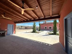an outdoor patio with awning and a ceiling fan at La Casa Rosa in Burgos