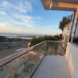 a balcony of a house with a view of the beach at Atlantic Resort in Jaliapāra