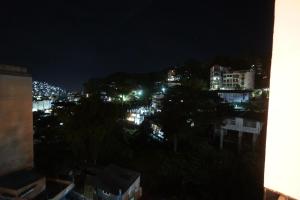 a view of a city at night with lights at House of Joe - City Center in Baguio