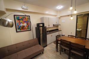 a kitchen and dining room with a table and a refrigerator at House of Joe - City Center in Baguio