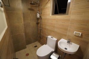 a bathroom with a toilet and a sink at House of Joe - City Center in Baguio +19 photos