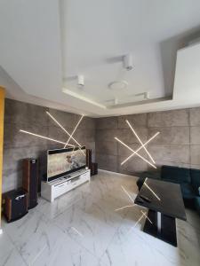 a living room with a flat screen tv on a wall at Apartament Dubaj in Gliwice +12 photos