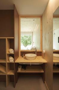 a bathroom with a sink and a window at Hotel Amiuka in O Pedrouzo