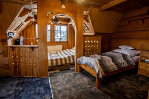 a bedroom with two beds in a log cabin at Dom Zako in Zakopane
