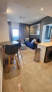 a living room with a table and a couch at Oceans Apartments Balcony Suites in the Radisson Blu Hotel Building Tower, Durban Umhlanga in Durban