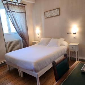 a bedroom with a large white bed and a window at Chateau Pontet d'Eyrans & Spa in Eyrans-de Soudiac