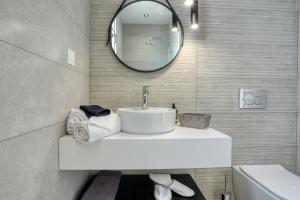 a bathroom with a sink and a mirror at Aegean Sunset Villas in Mastihari