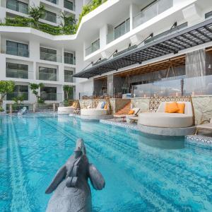 a swimming pool with an elephant in the middle of a building at Apec Mandala Condotel Sea View Comhomes Phú Yên in Tuy Hoa