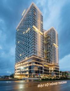 a rendering of a tall building with lights on it at Apec Mandala Condotel Sea View Comhomes Phú Yên in Tuy Hoa