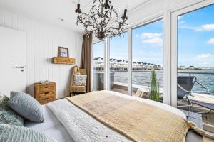 a bedroom with a bed and a view of the water at Wasserhaus Villa Sansibar in Olpenitz