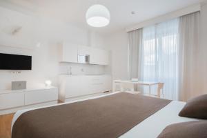 TV a/nebo společenská místnost v ubytování Felix Hotels - Residence Hotel Grandi Magazzini