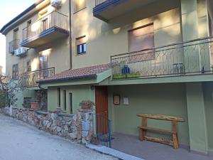 a bench sitting on the side of a building at La Finestra Sul Mare in Lanusei
