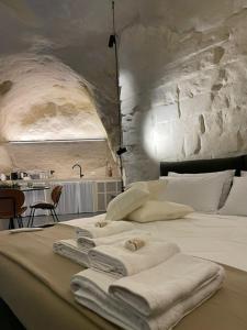a bedroom with a bed with towels on it at Marsili Suite in Matera