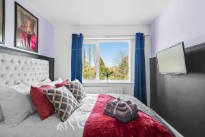 a bedroom with a bed with a large window at The Stylish Warwick Abode - Balcony - Garden in Leek Wootton