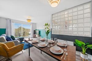 a living room with a table and a couch at The Stylish Warwick Abode - Balcony - Garden in Leek Wootton