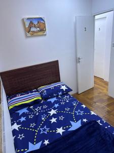 a bed with a blue comforter with stars on it at Decent Holiday Homes & Hostels near Burjuman Metro Station in Dubai