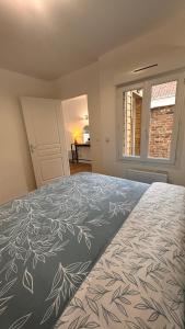 a bedroom with a bed with a leaf pattern on it at *Rivage* Spacieux T2 RDC sur cour:Jardin-Fibre-Netflix-Terrasse in Pont-de-Metz