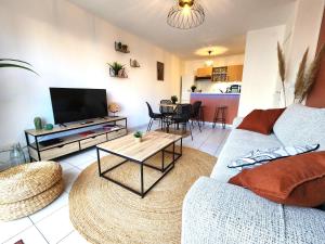 a living room with a couch and a table at Terra de Bègles in Bègles