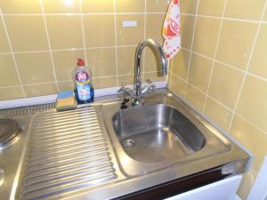 a stainless steel sink in a small kitchen at Ferienwohnung Roland in Balderschwang +29 photos