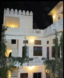 a white building at night with lights on it at Pushkar Guest House in Pushkar