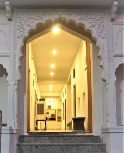 a hallway of a building with a large mirror at Pushkar Guest House in Pushkar