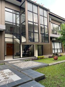 a large building with large windows and a lawn at Hotel Bima Majalengka in Majalengka