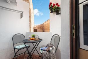a small table on a balcony with two chairs at Sunset apartment Es Celler in Alcudia