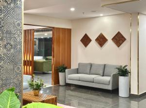 a living room with a couch and a table at The Habitat Suites in Guruvāyūr