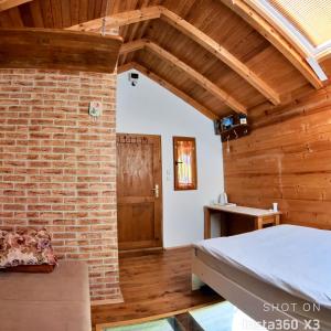 a room with a bed and a brick wall at Vacation Home Pliva in Šipovo