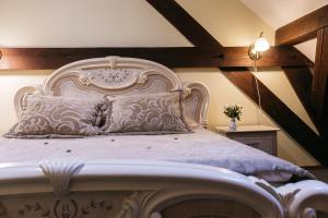 a bedroom with a large bed with a white headboard at Jaunmoku Palace Complex Hotel in Tume