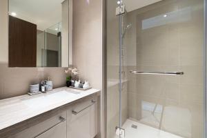 a bathroom with a shower and a sink and a mirror at Magnificent Cozy 2BR in Downtown Dubai in Dubai