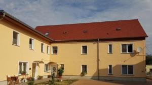 a large yellow building with a red roof at MontApart Geiseltal in Braunsbedra