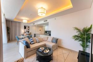 a living room with a couch and a table at Luxury Apartment Mina Azizi Palm Jumeirah-Private Beach in Dubai