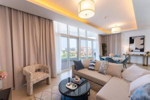 a living room with a couch and a table at Luxury Apartment Mina Azizi Palm Jumeirah-Private Beach in Dubai