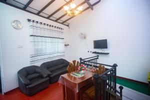 a living room with a couch and a table at Villa Kavee in Galle