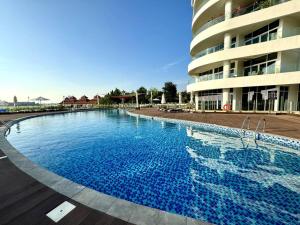 Luxury Apartment Mina Azizi Palm Jumeirah-Private Beach في دبي: مسبح كبير امام مبنى