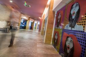 a hallway with paintings on the walls of a building at Hotel Da Vinci in Milan