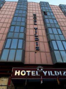 a hotel building with a sign in front of it at YILDIZ HOTEL in Altındağ